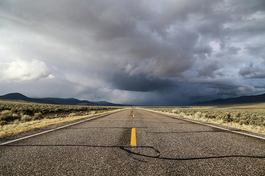 Storm on a Utah road Photograph by Alberto Zanoni