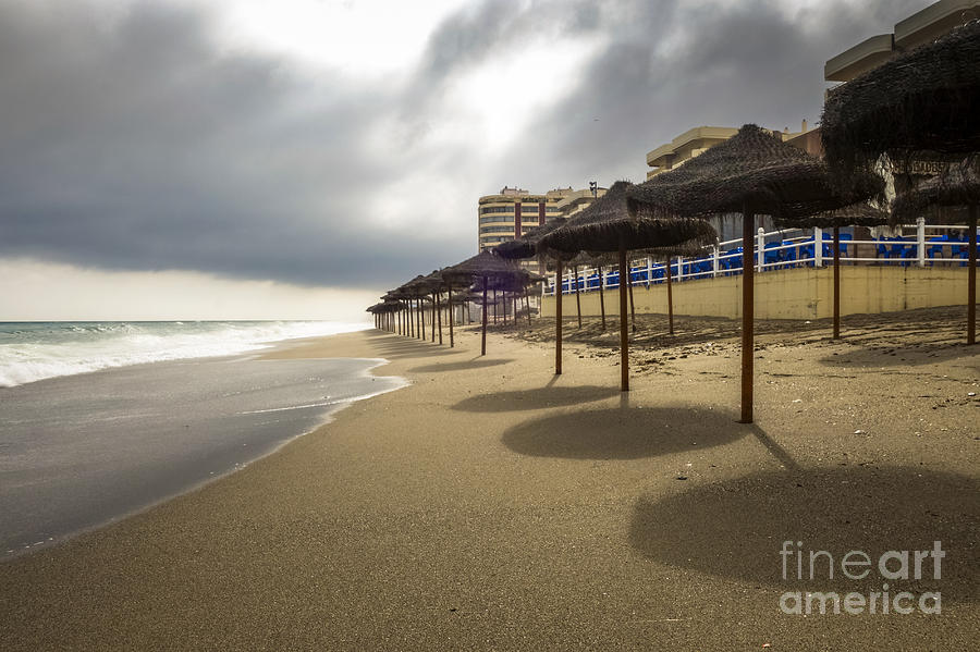 Stormy weather on Spanish beach Photograph by Perry Van Munster