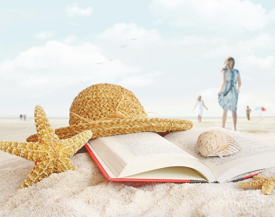 Straw hat  book and seashells in the sand Photograph by Sandra Cunningham