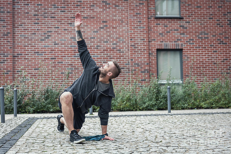 Streching in a city enviroment. Outdoor training. Photograph by Michal Bednarek