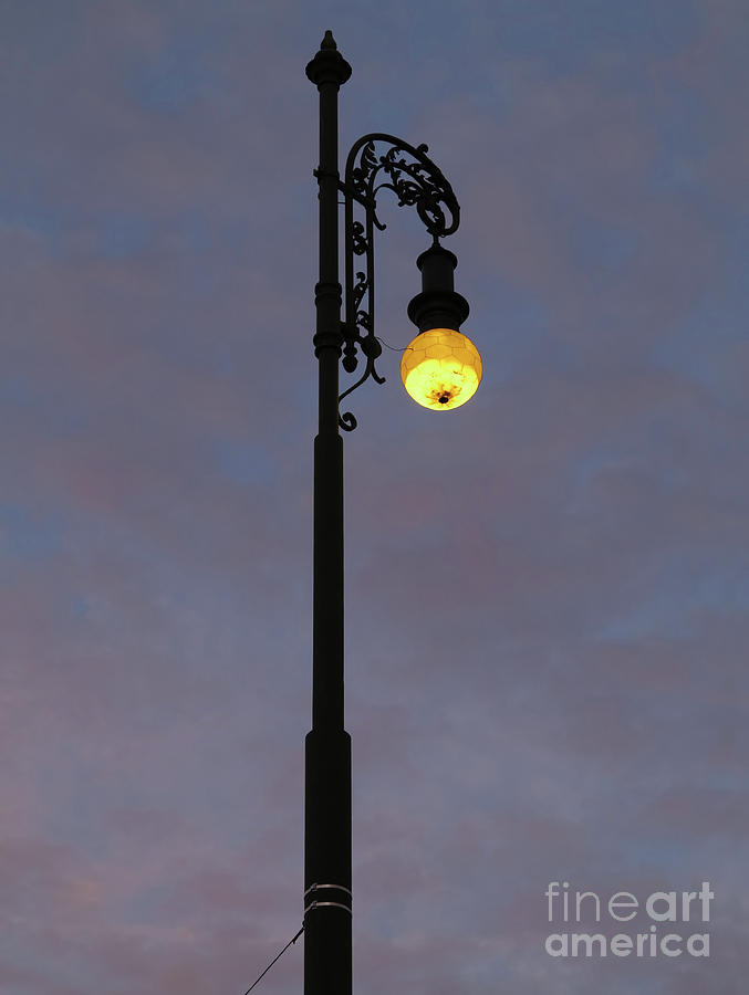 Street lamp shining at dusk Photograph by Michal Boubin