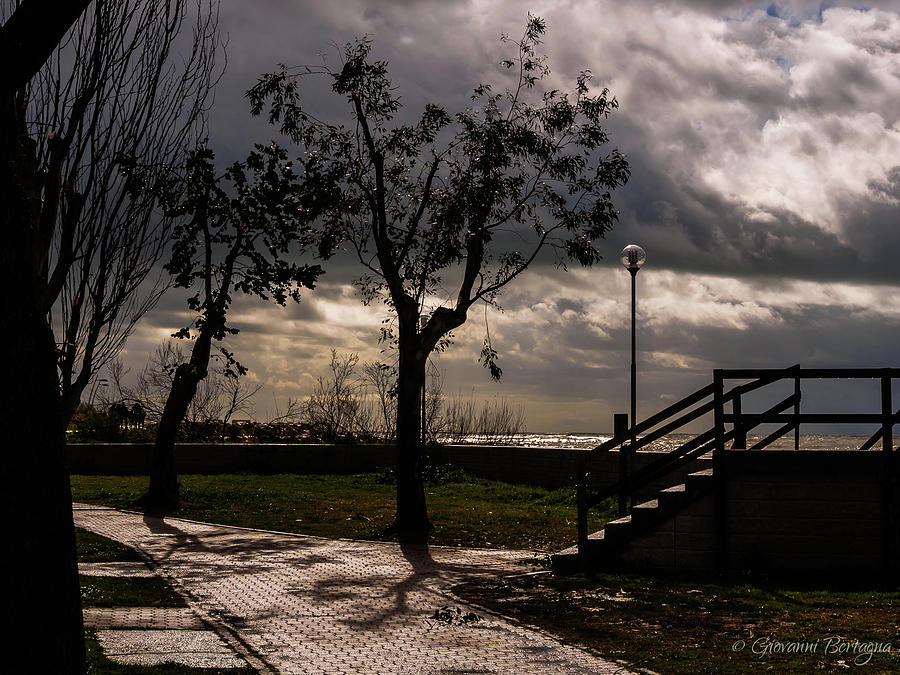 Strolling the waterfront on a stormy day by Giovanni Bertagna Strolling the waterfront on a stormy day by Giovanni Bertagna