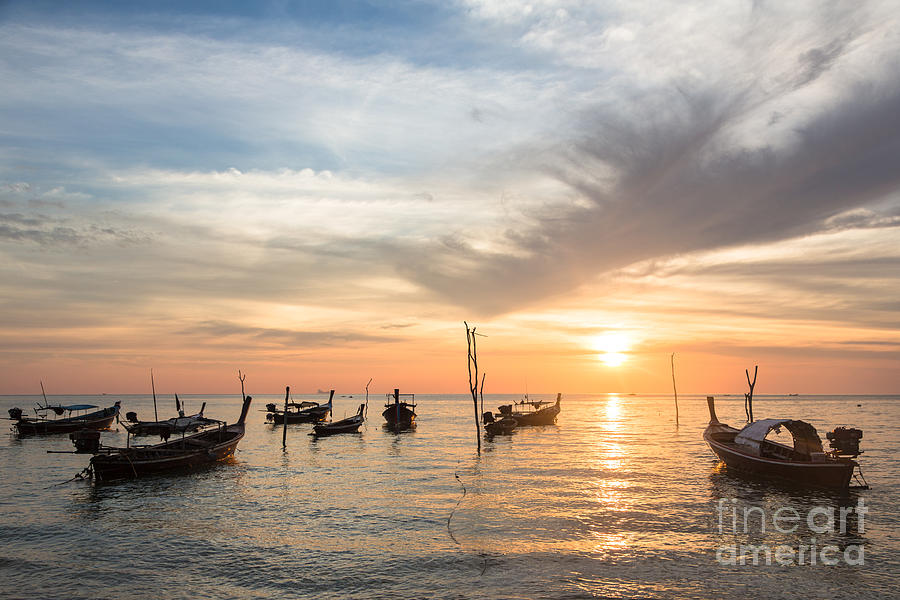 Stunning sunset over wooden boats in Koh Lanta in Thailand Photograph by Didier Marti