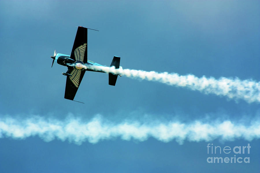 Stunt plane with smoke trails Photograph by Simon Bratt