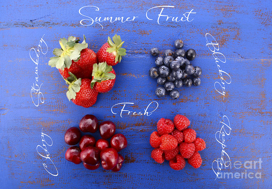 Summer fruit concept on dark blue wood table.  Photograph by Milleflore Images