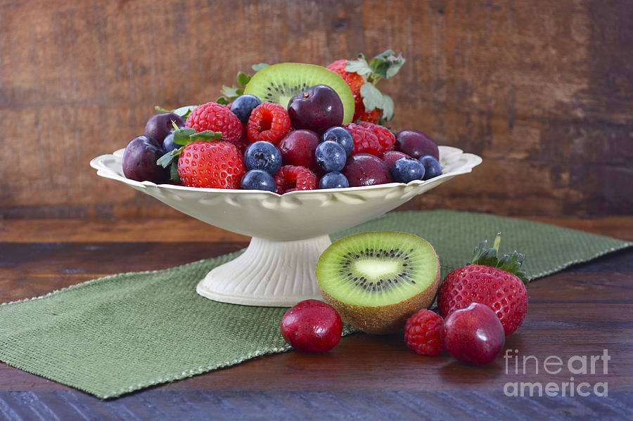 Summer Fruit in Vintage Bowl on Dark Wood Table.  Photograph by Milleflore Images