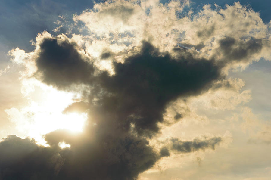 Nature Photograph - Sun braking trough dark clouds by Johan Ferret