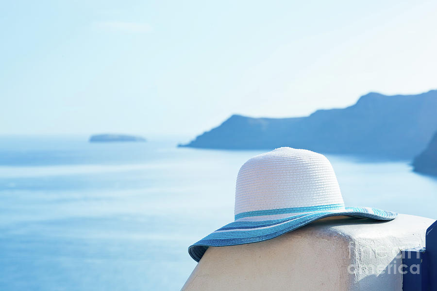 Sun hat on white stone wall on Santorini island, Greece. Travel, tourism Photograph by Michal Bednarek