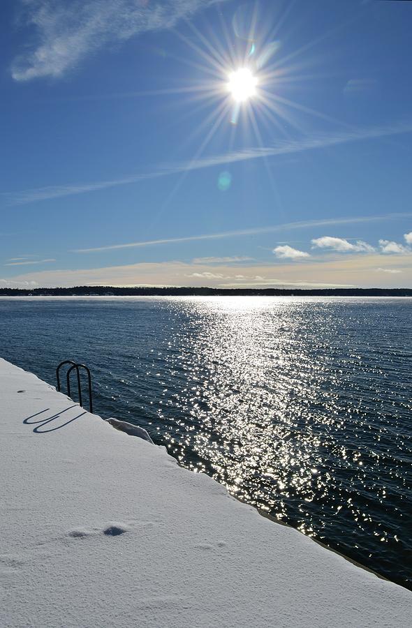 Sun Over The Water And Snow  Photograph by Lyle Crump