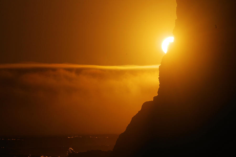 Sun peaking around a rock Photograph by Jeff Swan - Fine Art America