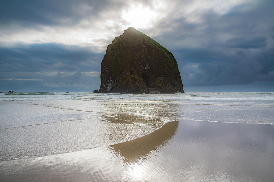 Sun Peaking Over Haystack Rock Photograph by Anthony Doudt