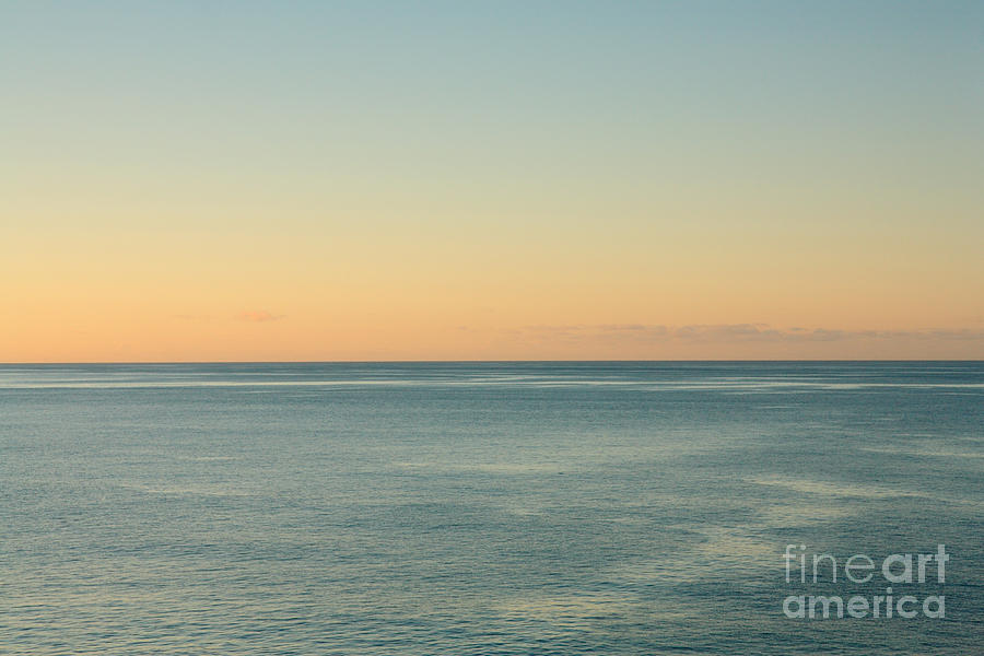 Sunrise and serene ocean Photograph by Gaspar Avila
