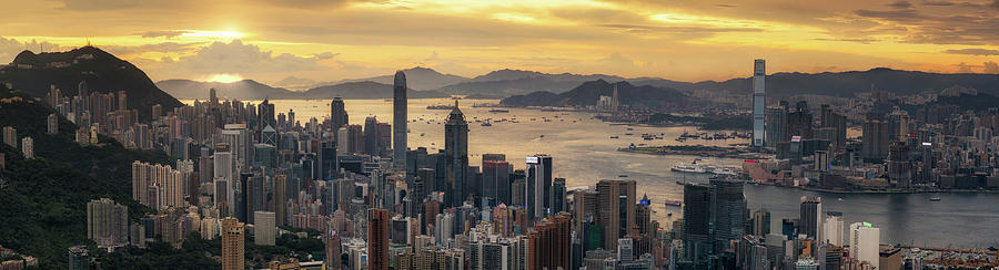Architecture Photograph - Sunrise day to night shot over Victoria Harbor  by Anek Suwannaphoom