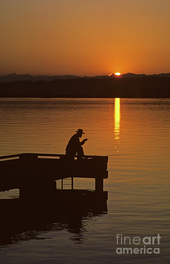 Sunrise Man Silhouetted Fishing off Dock Photograph by Jim Corwin