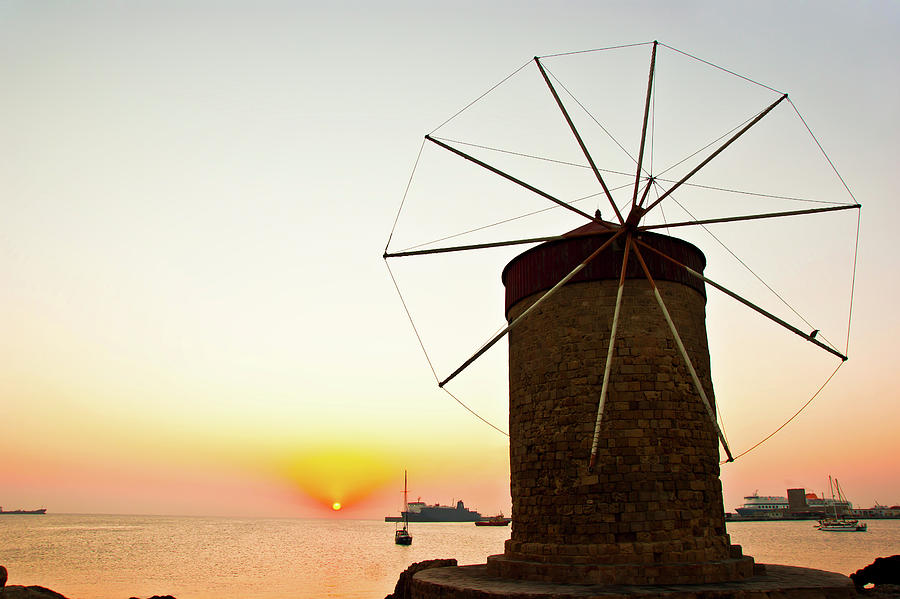 Sunrise, windmill and sea Photograph by Anna Kluba