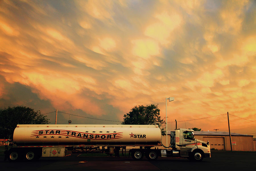 Sunset and a Star Transport Semi Truck Photograph by Toni Hopper