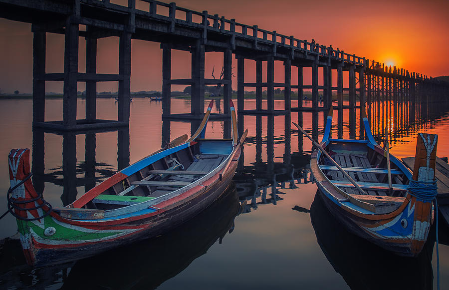 Sunset in U Bein bridge with vintage boat Photograph by Anek Suwannaphoom