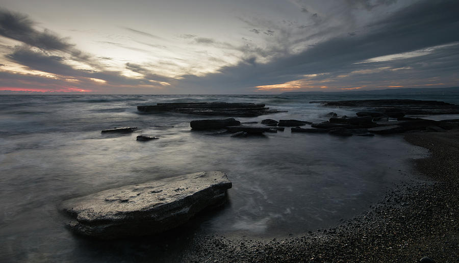 Sunset  on a rocky coastline Photograph by Michalakis Ppalis