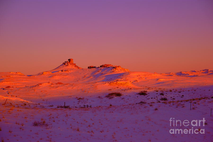 Sunset on a snowy hill Photograph by Jeff Swan