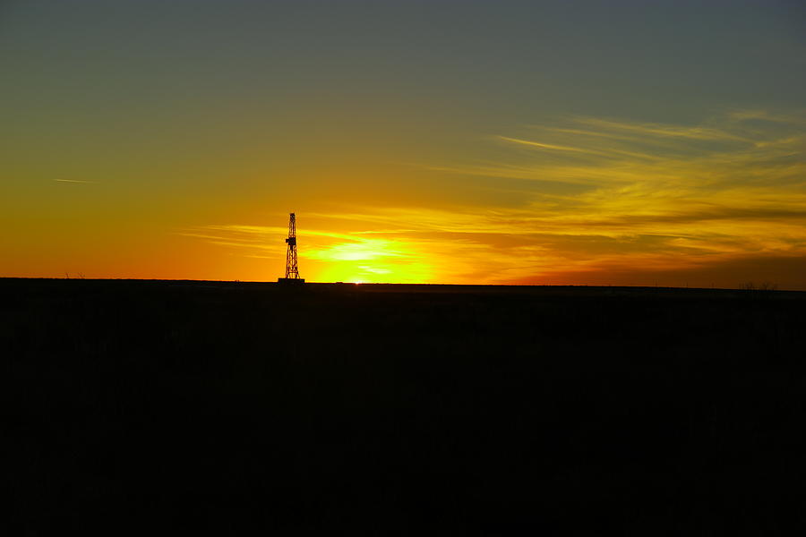 Sunset on an oil rig Jal New Mexico Photograph by Jeff Swan