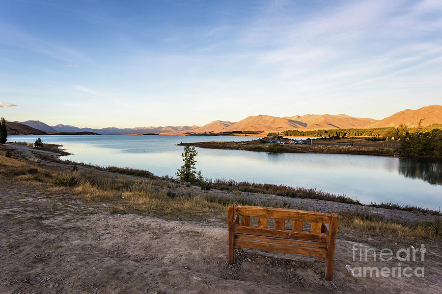 Sunset over a bench overlooking the stunning Lake Tekapo in New  Photograph by Didier Marti