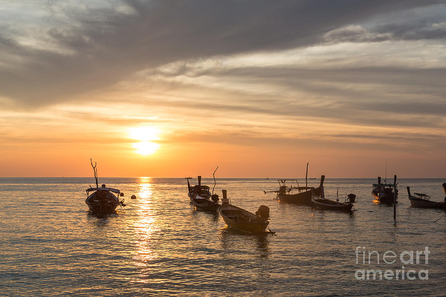 Sunset over boats in Koh Lanta in Thailand Photograph by Didier Marti