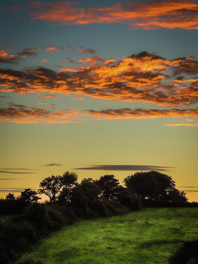 Sunset over green pastures Photograph by James Truett