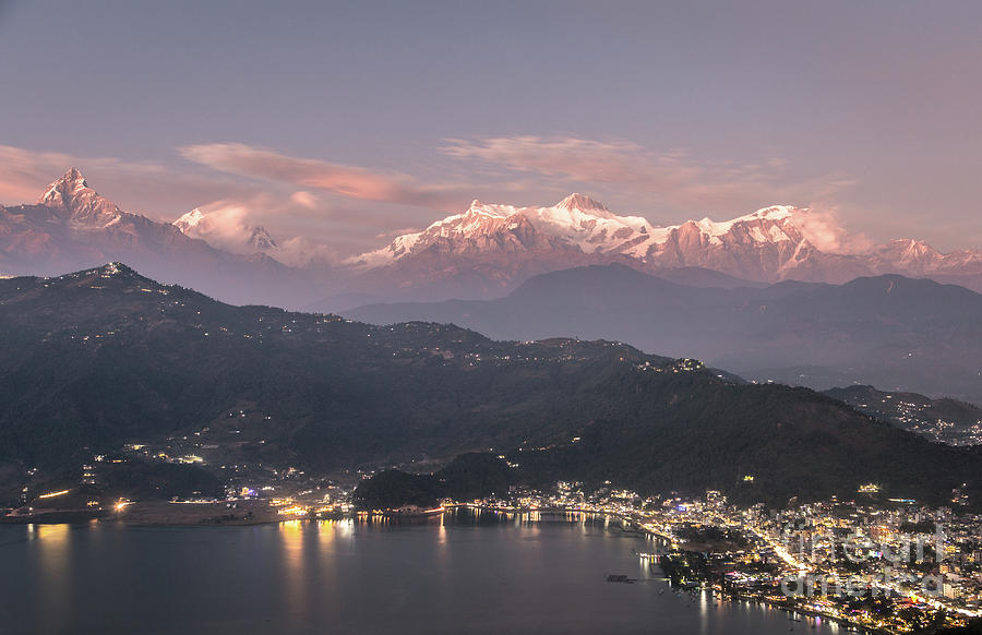 Sunset over Pokhara and the massive Annapurna mountain range in  Photograph by Didier Marti