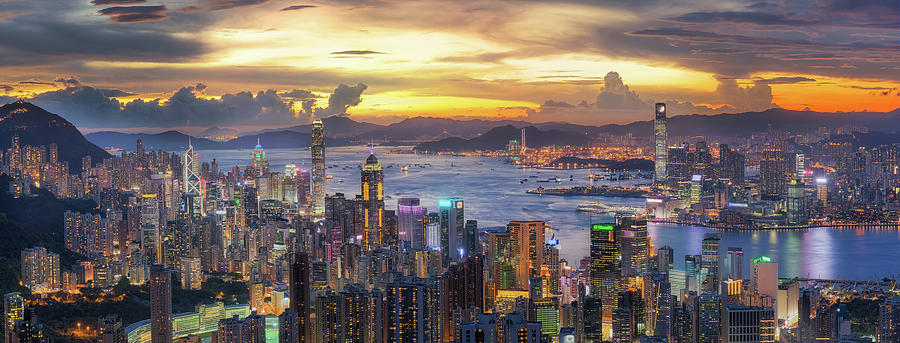 Sunset over Victoria Harbor as viewed atop Victoria Peak with Ho Photograph by Anek Suwannaphoom
