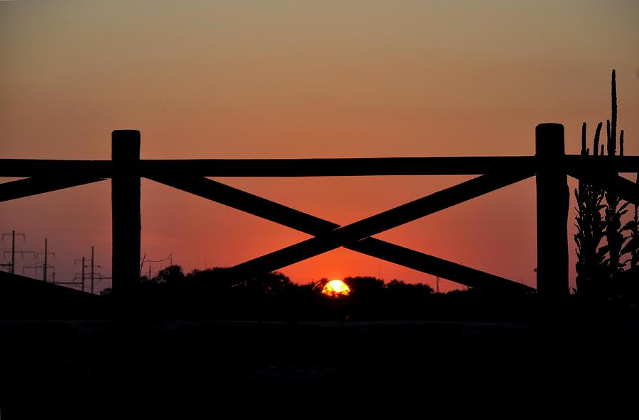 Sunset Through The Fence Photograph