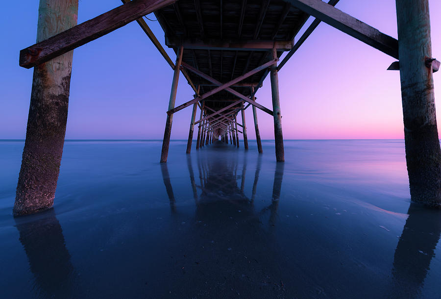 Sunset under a Fishing Pier on the Atlantic Ocean in North Carolina Photograph by Ranjay Mitra