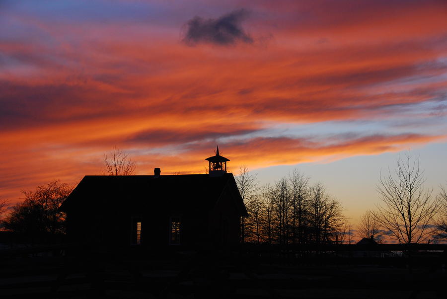 Sunsetting behind the historic Schoolhouse. Photograph by Wanda Jesfield