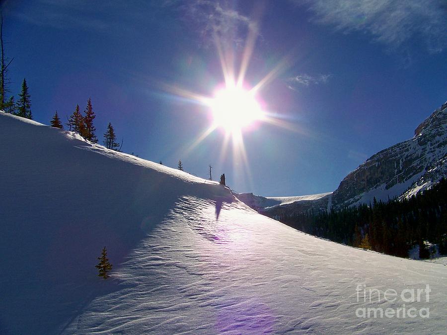 Sunstar Illuminates Patterns In Snow Photograph by Greg Hammond