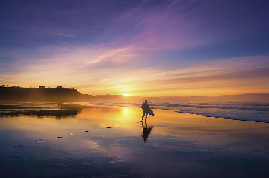 Surfer In Beach At Sunset Photograph by Mikel Martinez de Osaba