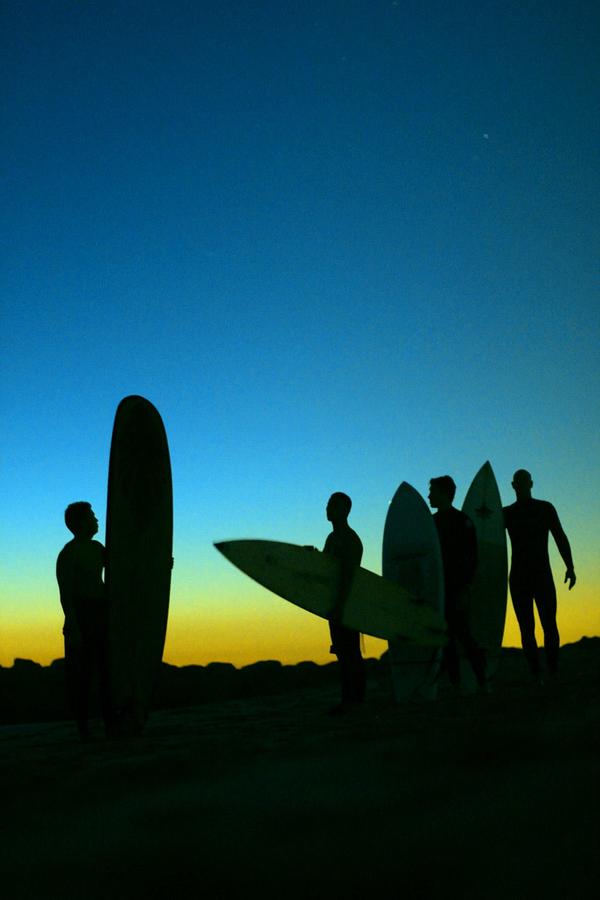 Sunset Photograph - Surfers After Sunset by Juan Pazos