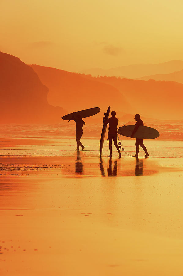 Sunset Photograph - Surfers At Sunset by Mikel Martinez de Osaba