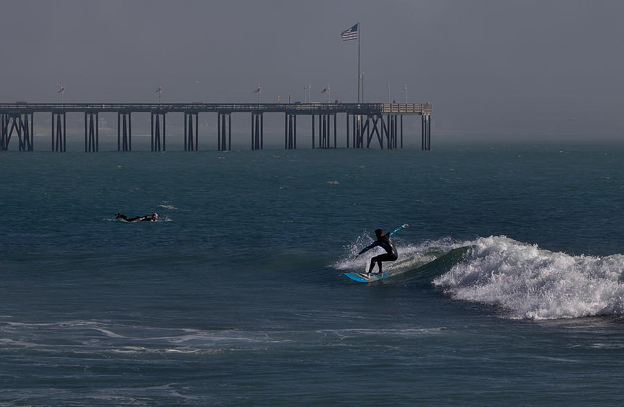 Surfing off the Pier Photograph by Michael Gordon