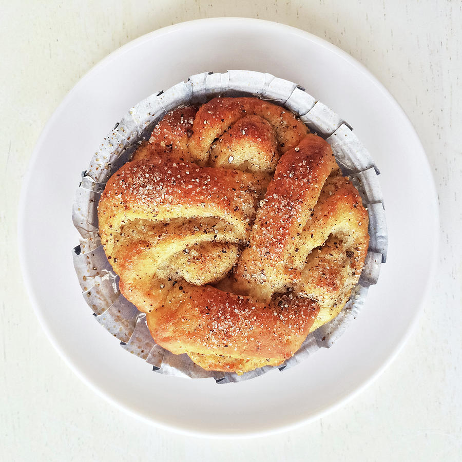 Snack Photograph - Sweet cardamom bun on a plate by GoodMood Art
