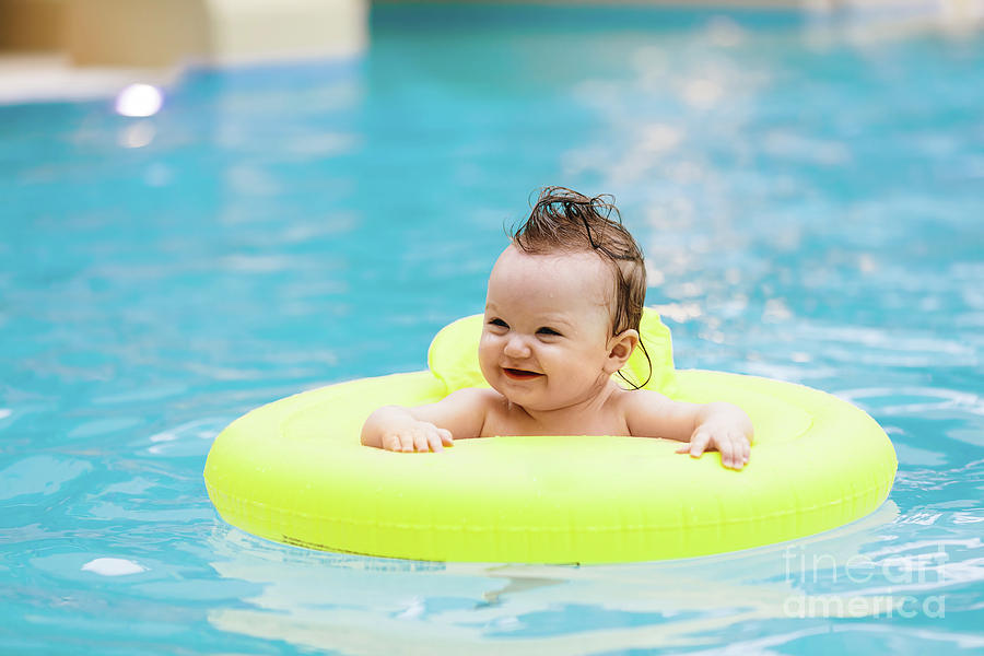 Sweet toddler swimming in a floating ring Photograph by Michal Bednarek