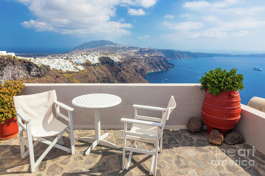 Table and chairs on roof with a panorama view on Santorini island, Greece. Photograph by Michal Bednarek