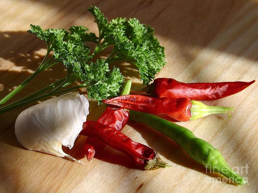 Table with chillies chili peppers garlic parsley Photograph by Vintage Collectables