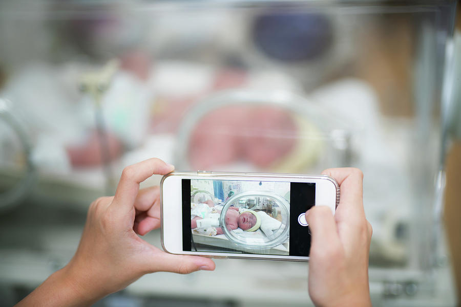 Take a photo for new born baby in hospital by use smart mobile p Photograph by Anek Suwannaphoom