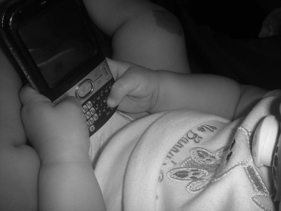 Taking her first baby text..... Photograph by WaLdEmAr BoRrErO