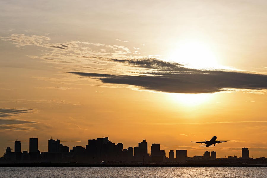 Taking off. Sunset over Boston MA and Logan Airport Photograph by Toby McGuire