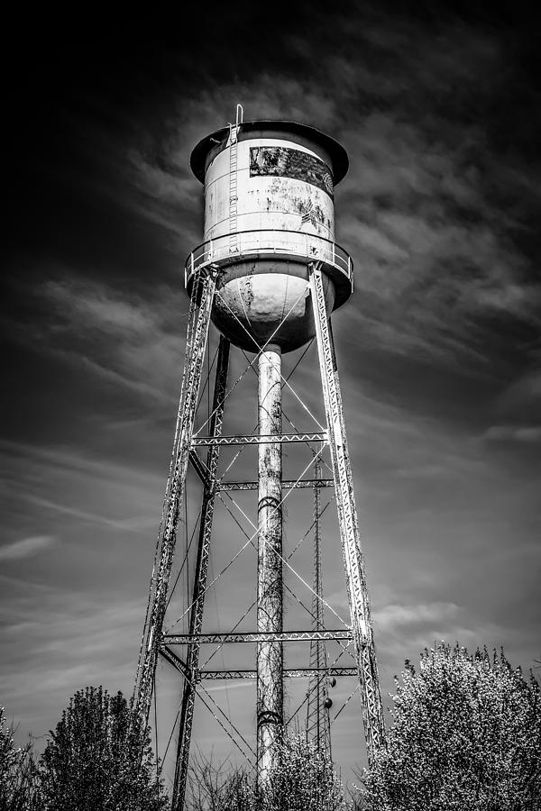 Architecture Photograph - Tall  water tower with cloudy blue sky background by Alex Grichenko