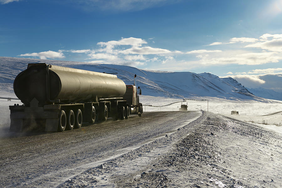 Tankers and trucks driving the Dalton Highway through the Brooks Photograph by Reimar Gaertner