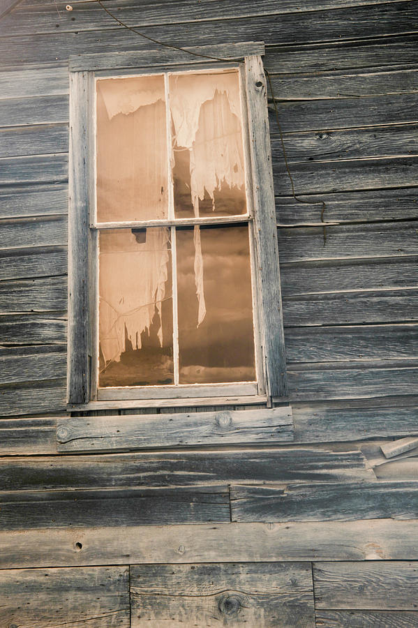 Tattered curtains in window in  Photograph by Karen Foley
