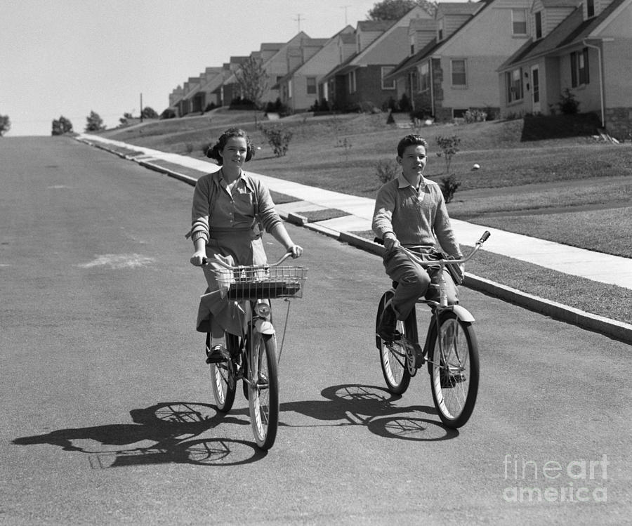 Teen Boy And Girl Riding Bikes, C.1950s Photograph by H. Armstrong Roberts/ClassicStock