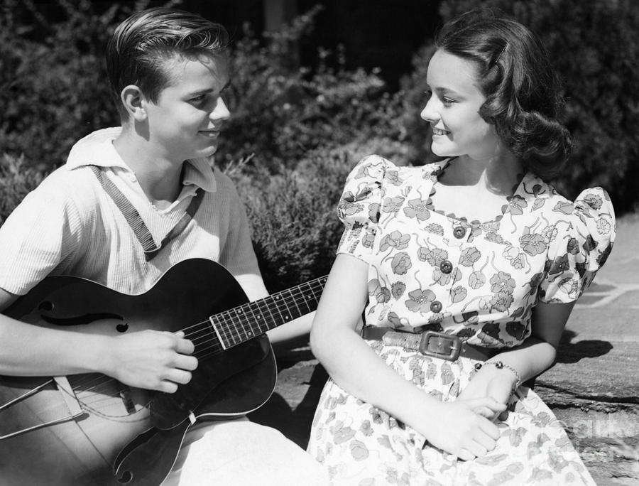 Guitar Photograph - Teen Boy Serenading Girl With Guitar by H. Armstrong Roberts/ClassicStock