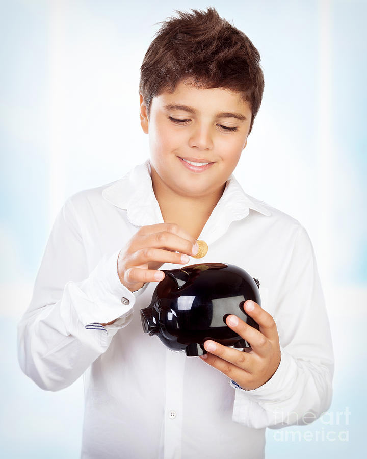 Teen boy with piggy bank Photograph by Anna Om